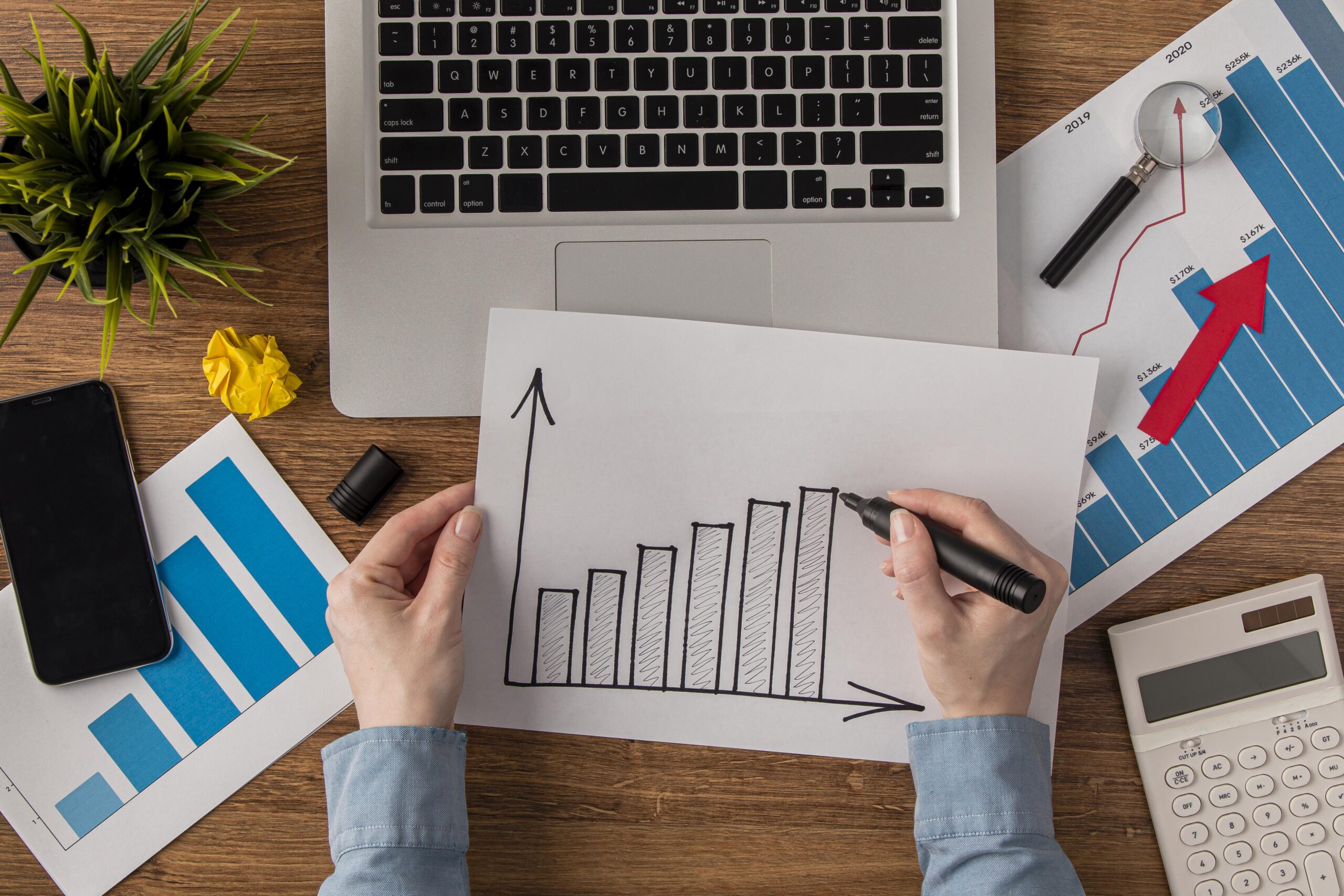 top view office desk with calculator growth chart scaled